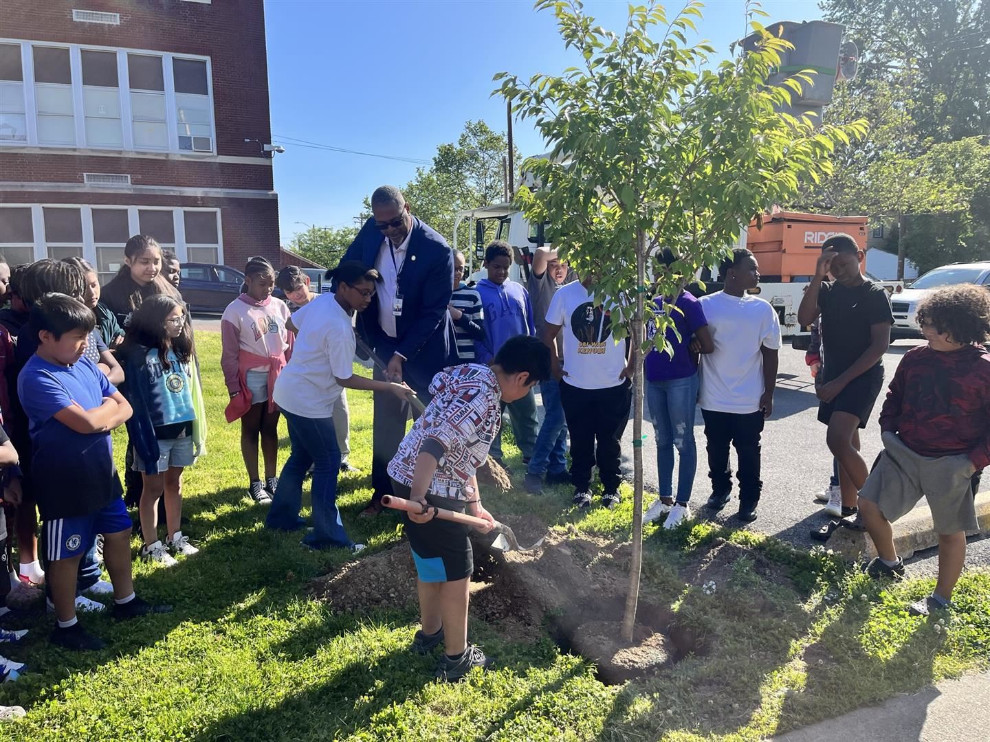  Superintendent Dr. Rosser helps students plant a tree at Warring Elementary School 