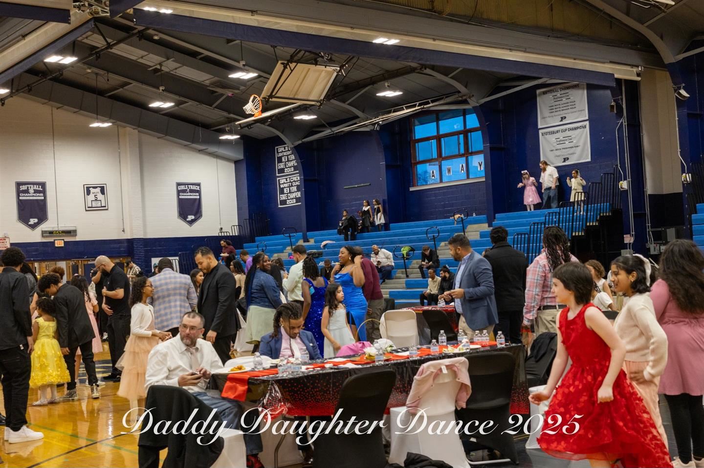 Fathers and daughters enjoy a daddy daughter dance.