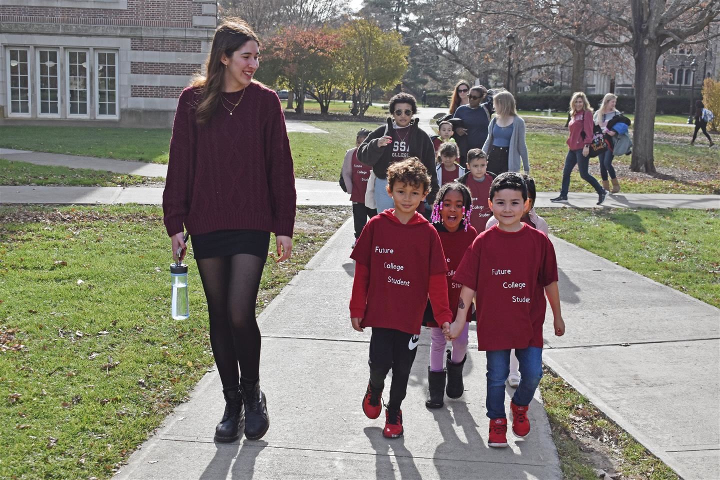  Vassar Sophomore Shayni Richter leads first graders from the Early Learning Center towards the coll