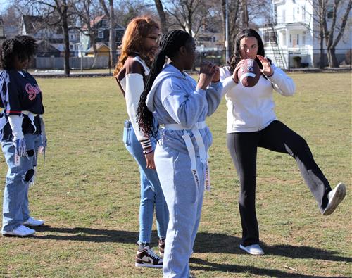 coac teaching how to throw a football