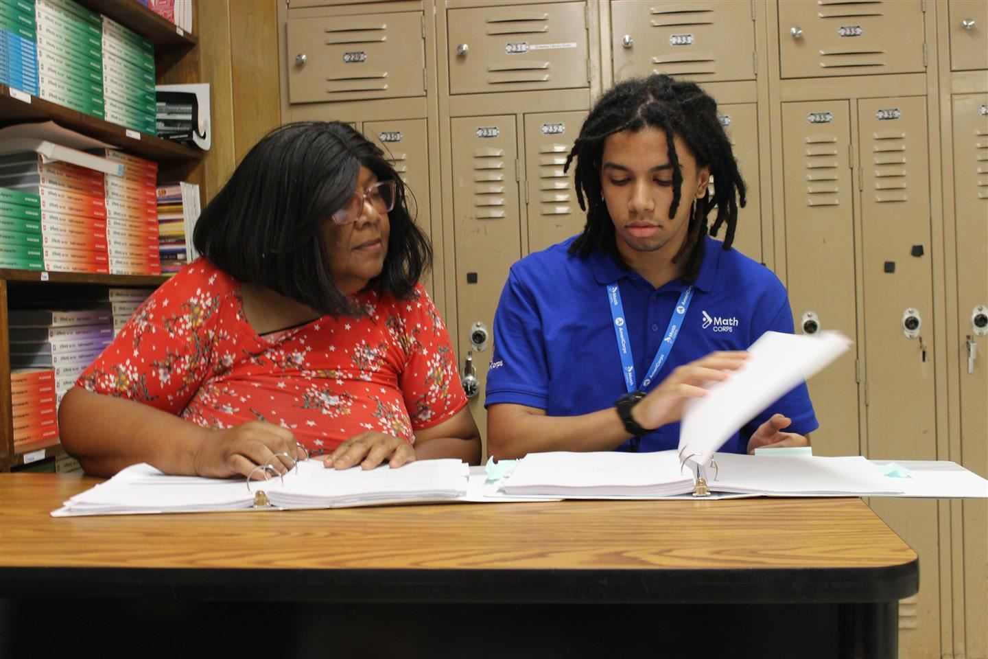  Philene Tanner and Jahmir Reeder of the Math Corps tutors read through documents at MES.