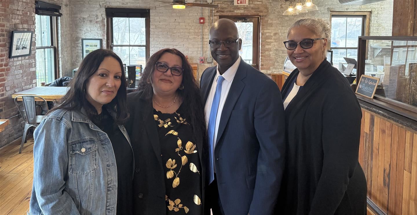 Four school leaders pose together