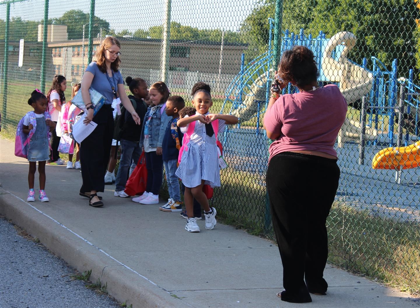  Ni'Yah Harris poses after getting off the bus for the first day of Kindergarten