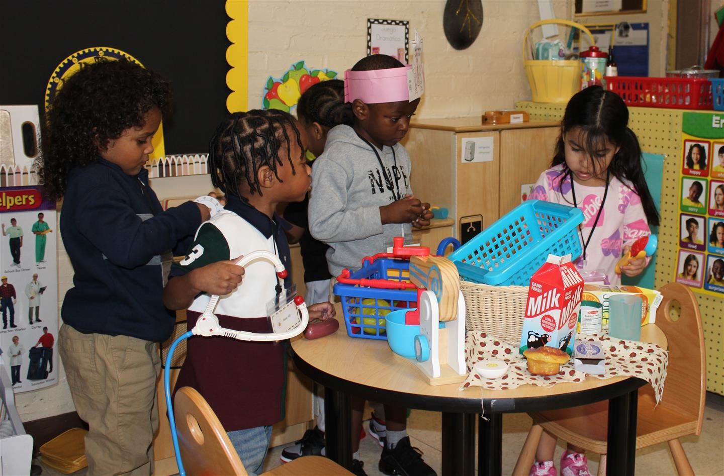  Four pre-K students play at a table