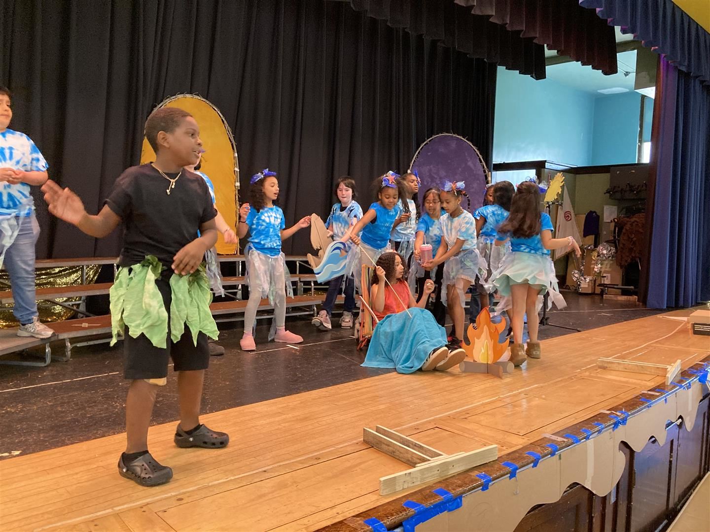  Students dance on stage in a play