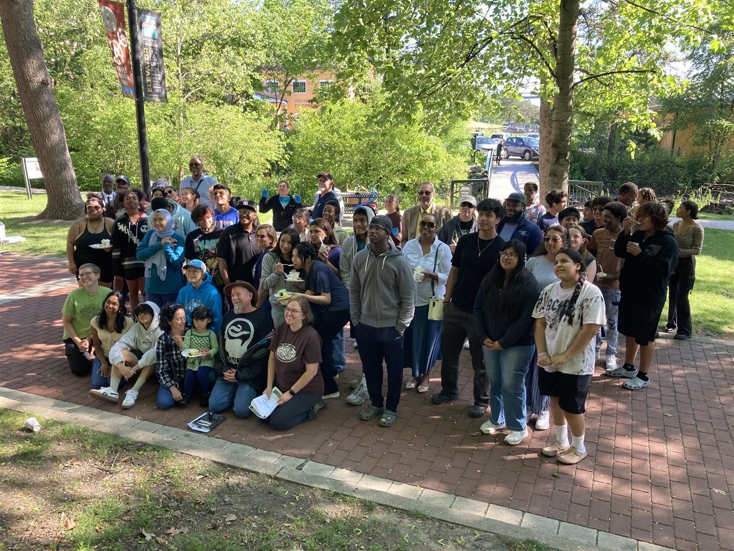  A group of people pose for a photo outside.