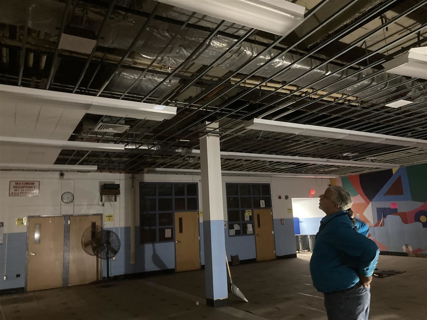 Director of Facilities Marcos Rodriguez looks at the ceiling in Poughkeepsie Middle School’s cafeteria last week.